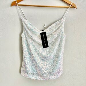Cute sequin top size S.  The blazers shown in the photos are not included.